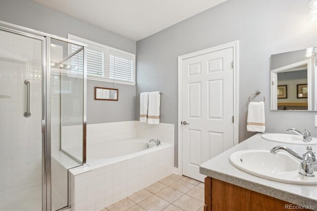 2723 Galena St, Denver, CO 80238 - full bath featuring a stall shower, double vanity, a garden tub, and tile patterned floors