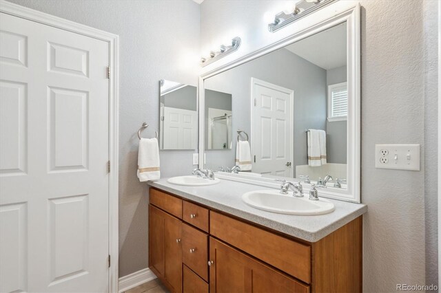2723 Galena St, Denver, CO 80238 - full bath with double vanity and a textured wall