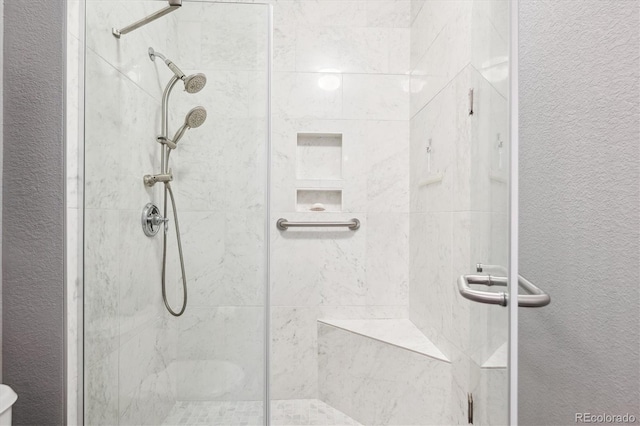 2723 Galena St, Denver, CO 80238 - bathroom featuring a stall shower, toilet, and a textured wall