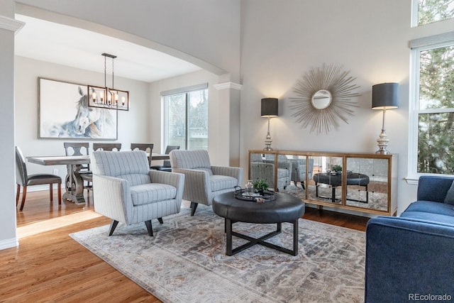 living room with hardwood / wood-style floors and an inviting chandelier