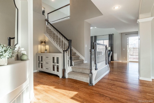 staircase with hardwood / wood-style flooring