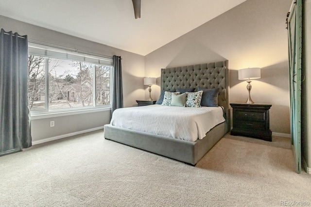 carpeted bedroom featuring ceiling fan and vaulted ceiling