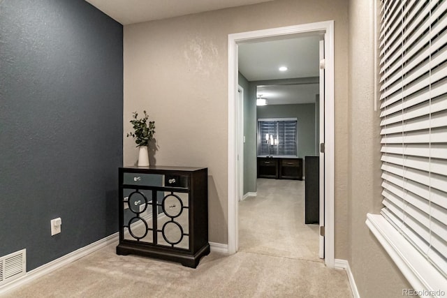 hallway with light carpet