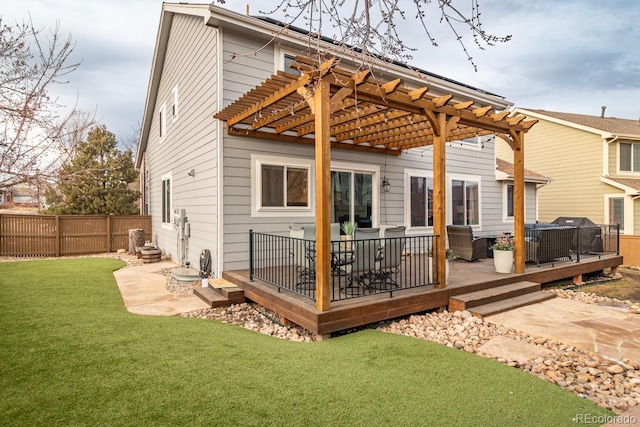 back of house with a yard, a pergola, a wooden deck, an outdoor living space, and a patio