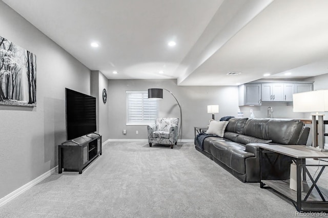 living room with sink and light colored carpet