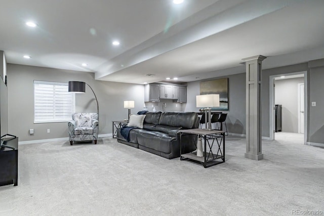 living room featuring decorative columns and light carpet