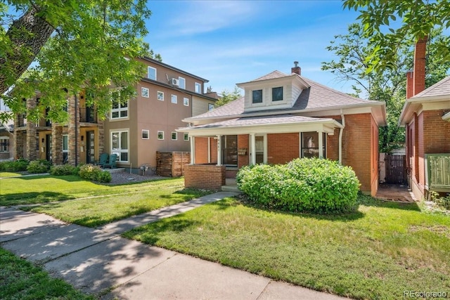 4461 Vrain St, Denver, CO 80212 - view of front of home with covered porch, brick siding, a chimney, and a shingled roof