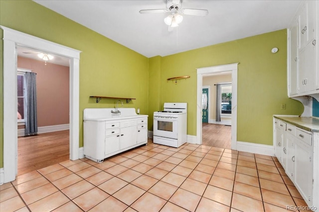 4461 Vrain St, Denver, CO 80212 - kitchen featuring white gas range, ceiling fan, light countertops, and white cabinets