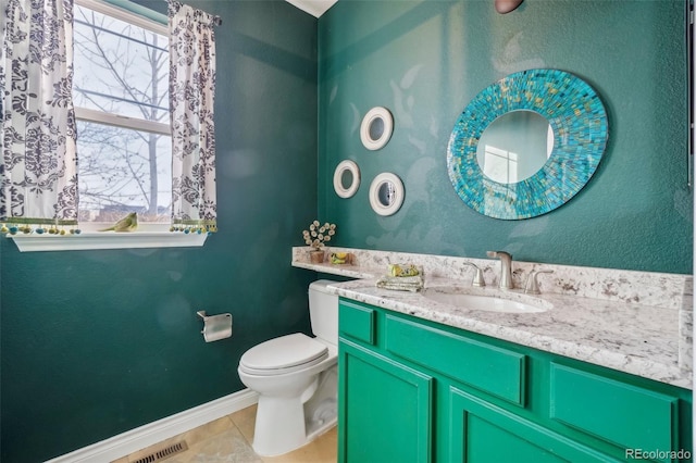 bathroom with vanity, tile patterned floors, and toilet