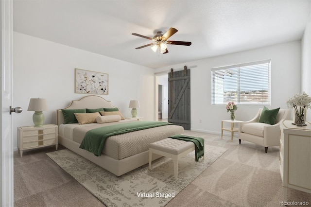 carpeted bedroom featuring a barn door and ceiling fan