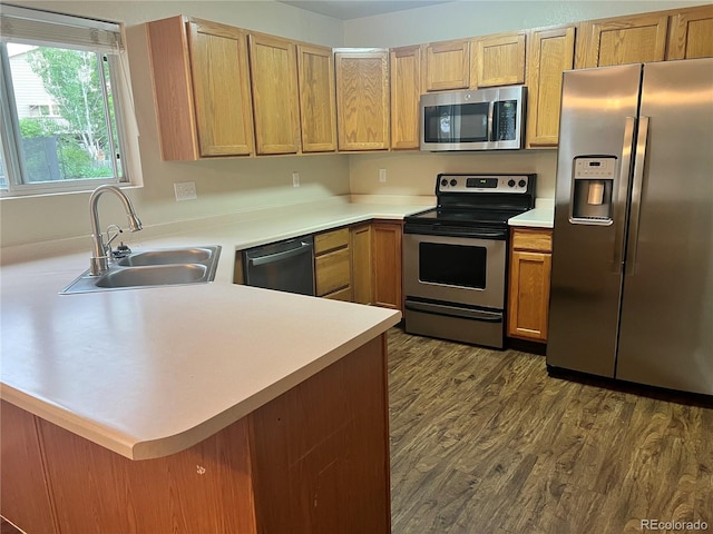 21767 Silver Meadow Ln, Parker, CO 80138 - kitchen with appliances with stainless steel finishes, light countertops, a peninsula, and dark wood-type flooring
