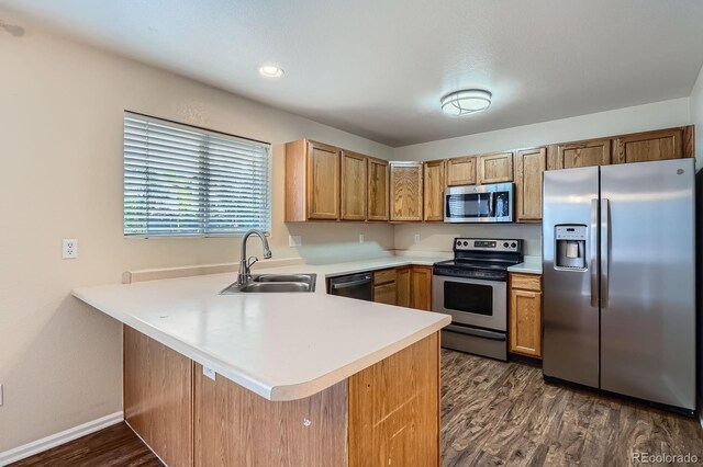 21767 Silver Meadow Ln, Parker, CO 80138 - kitchen featuring stainless steel appliances, a peninsula, light countertops, and dark wood-style flooring