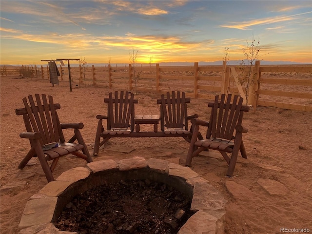 patio terrace at dusk featuring a fire pit