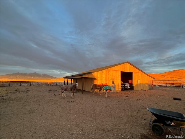 exterior space with an outdoor structure, a rural view, and a mountain view