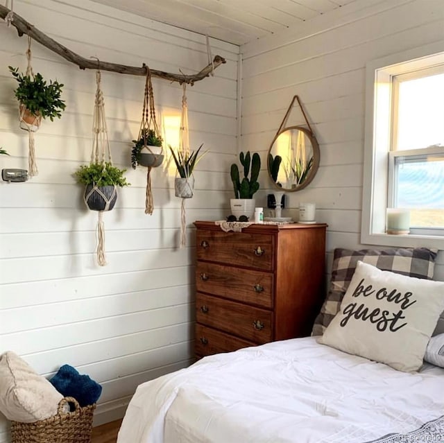 bedroom featuring wood ceiling, wood-type flooring, and wood walls