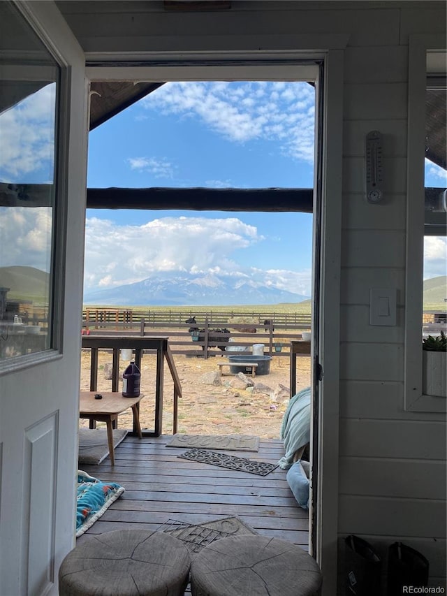 wooden terrace featuring a mountain view and a rural view