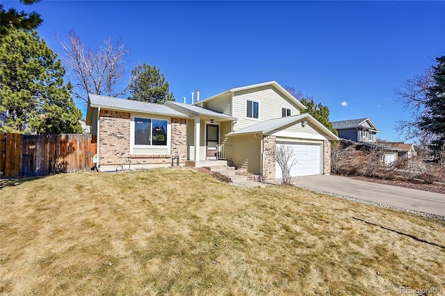 tri-level home featuring brick siding, concrete driveway, fence, metal roof, and a front lawn