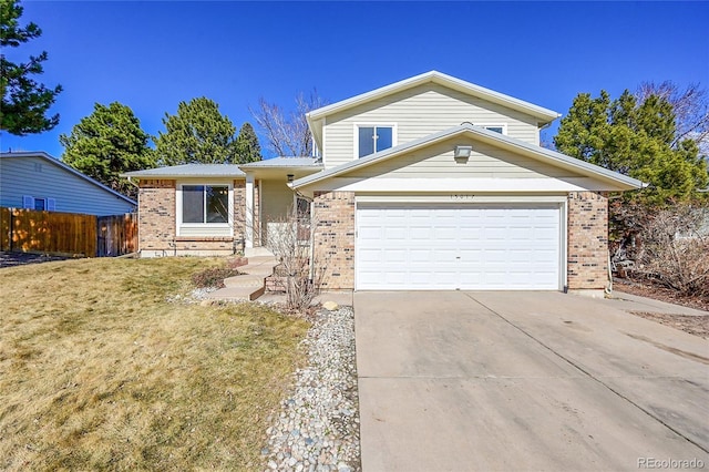 view of front of home featuring driveway, a garage, fence, and brick siding