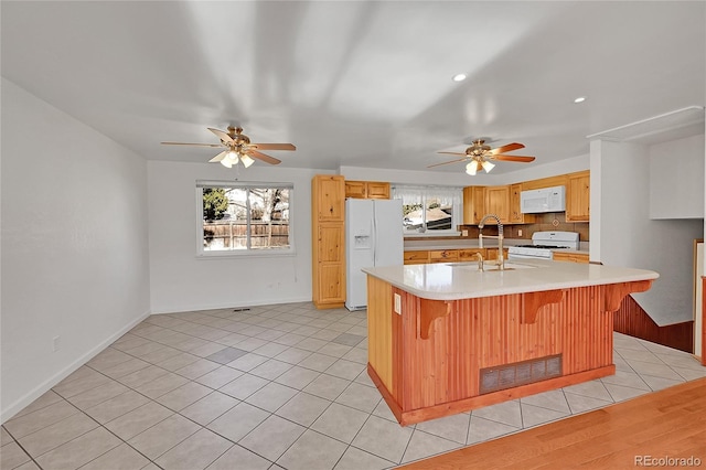 kitchen featuring light countertops, visible vents, light tile patterned flooring, a sink, and white appliances