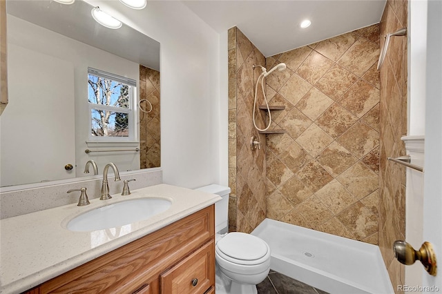 bathroom featuring vanity, a shower stall, and toilet