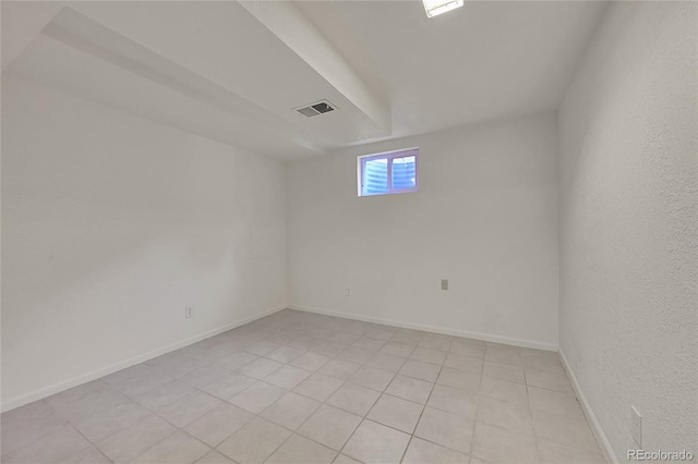 spare room featuring visible vents and baseboards