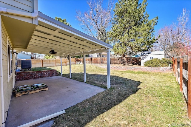 view of yard featuring a patio area, a fenced backyard, and central air condition unit