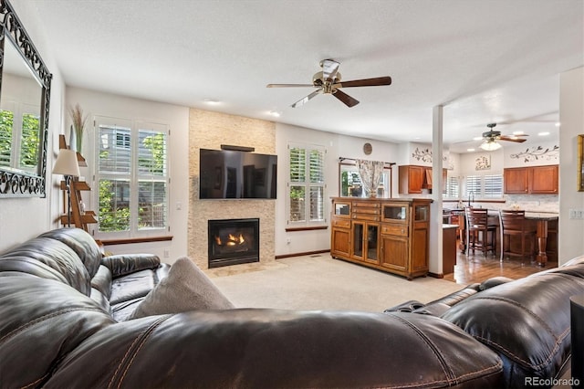 7804 Silverweed Way, Lone Tree, CO 80124 - living room featuring ceiling fan, healthy amount of natural light, a large fireplace, and light carpet