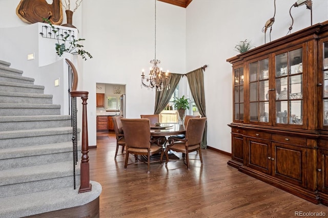 7804 Silverweed Way, Lone Tree, CO 80124 - dining area with a high ceiling, stairway, dark wood-style flooring, a chandelier, and baseboards