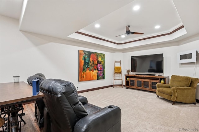 7804 Silverweed Way, Lone Tree, CO 80124 - carpeted cinema room featuring ceiling fan, a tray ceiling, recessed lighting, baseboards, and ornamental molding