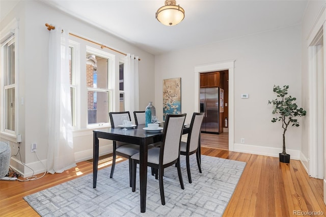 1121 S Ogden St, Denver, CO 80210 - dining room with light wood-type flooring and baseboards