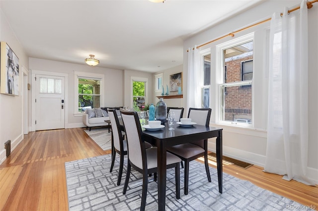 1121 S Ogden St, Denver, CO 80210 - dining room featuring light wood-style floors and baseboards