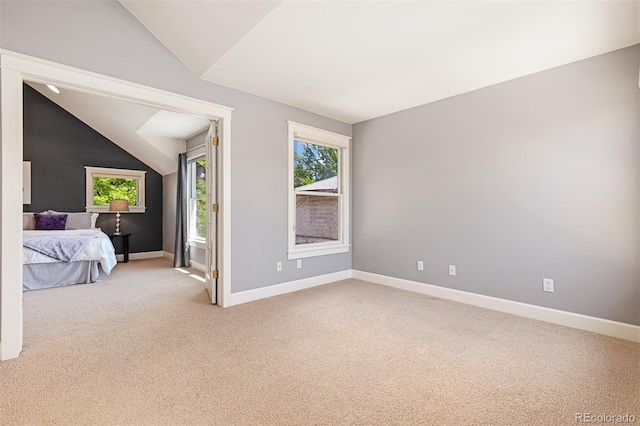 1121 S Ogden St, Denver, CO 80210 - unfurnished bedroom with lofted ceiling, light carpet, and baseboards
