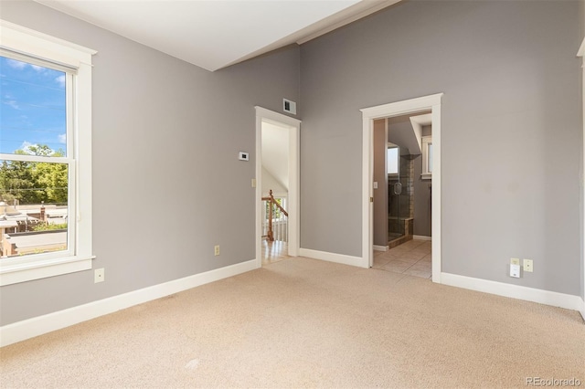 1121 S Ogden St, Denver, CO 80210 - unfurnished bedroom featuring light colored carpet, baseboards, and ensuite bathroom