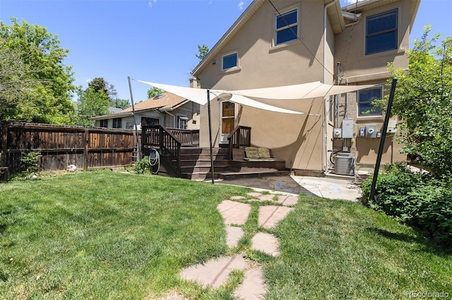 1121 S Ogden St, Denver, CO 80210 - rear view of house with stucco siding, central air condition unit, a wooden deck, and a patio area