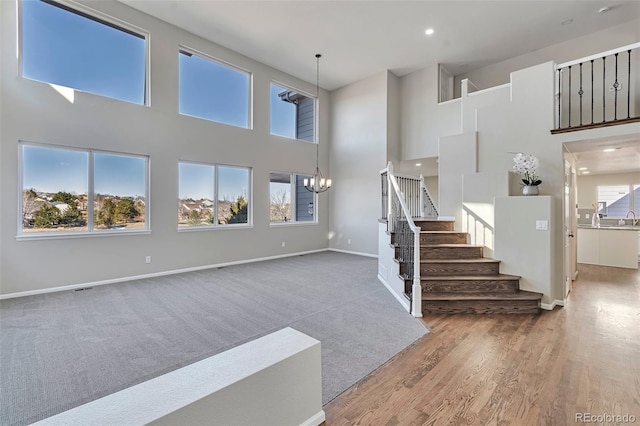 living room with hardwood / wood-style floors, a wealth of natural light, and a high ceiling