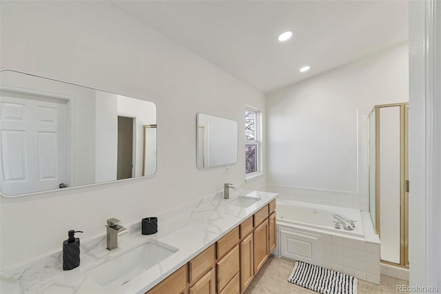 bathroom with vanity and shower with separate bathtub