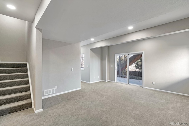 basement featuring light colored carpet