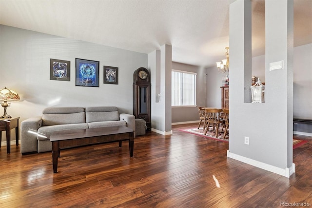 living room with dark hardwood / wood-style floors and a notable chandelier