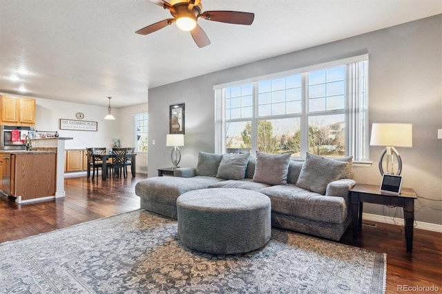 living room with dark hardwood / wood-style floors and ceiling fan