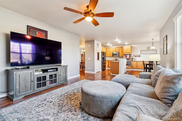 living room featuring hardwood / wood-style floors and ceiling fan