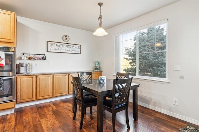 dining space with dark hardwood / wood-style flooring