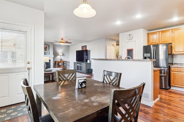 dining space with ceiling fan and dark hardwood / wood-style floors