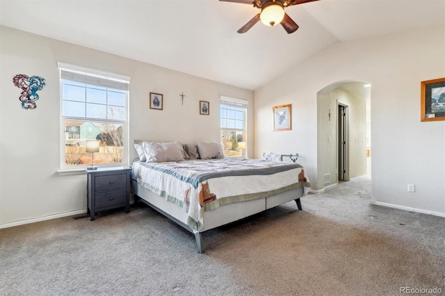 carpeted bedroom with ceiling fan and vaulted ceiling