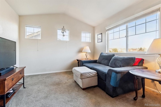 living room featuring plenty of natural light, light colored carpet, and lofted ceiling