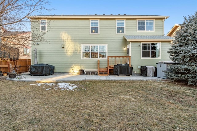 rear view of property featuring a patio and a lawn