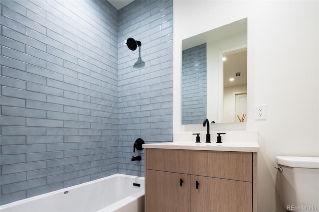 full bathroom with toilet, vanity, and tiled shower / bath combo