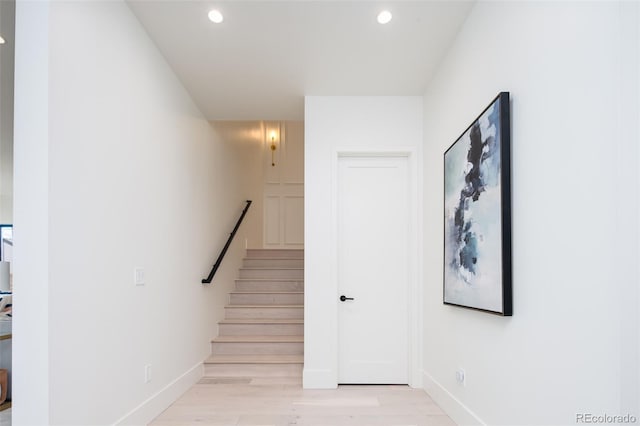 staircase with hardwood / wood-style flooring