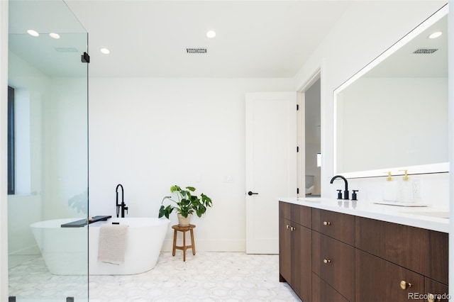 bathroom with a washtub and vanity