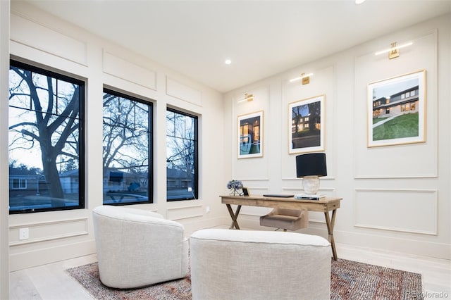 office space with a decorative wall, wood finished floors, and recessed lighting