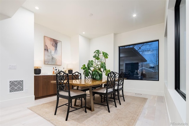 dining space with baseboards, visible vents, and recessed lighting